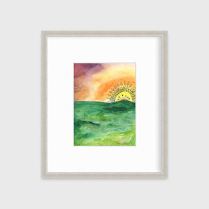 A multicolored abstract landscape print in a silver frame with a mat hangs on a white wall.