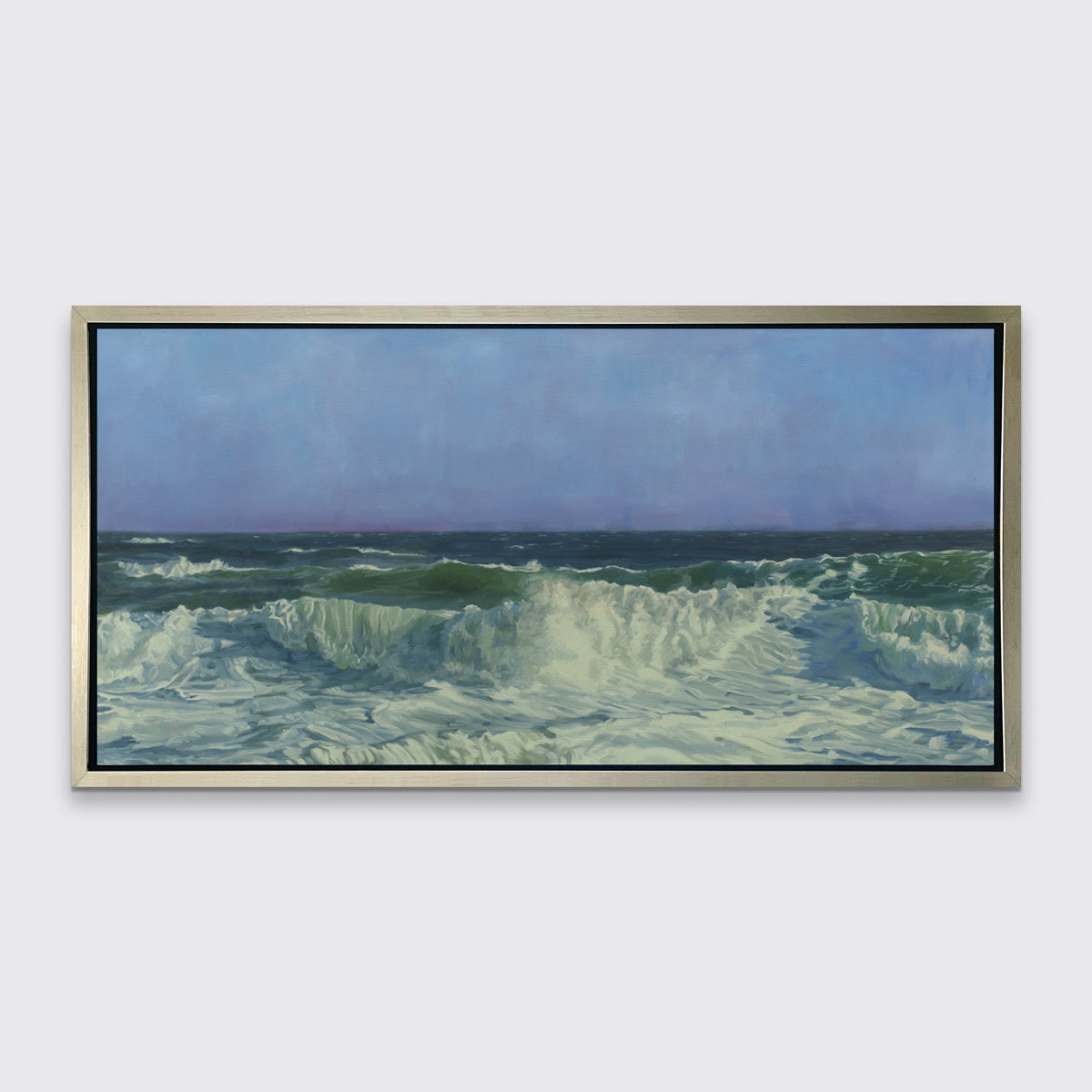A blue, teal, white and light green abstract water wave print in a silver floater frame hangs on a white wall.