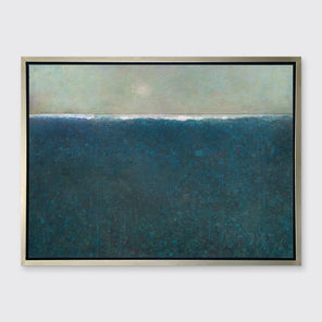 A deep blue abstract landscape print in a silver floater frame hangs on a white wall.