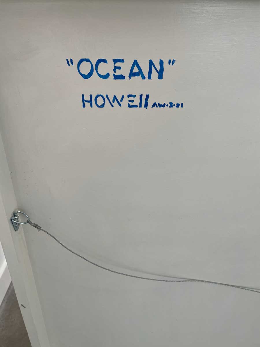 A up close detail of the back of the panel with title and artist's name.
