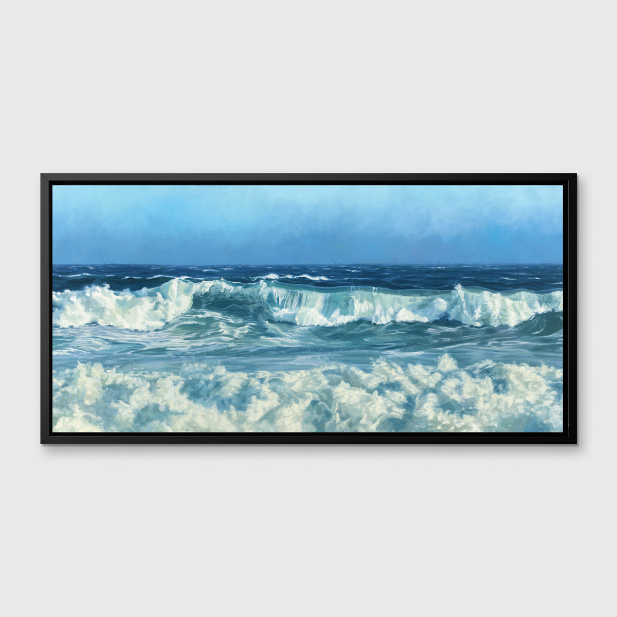 A blue and white seascape print in a black floater frame hangs on a white wall.