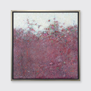 A dark red abstract landscape print in a silver floater frame hangs on a white wall.