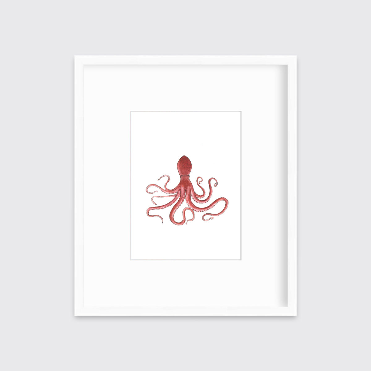 A pink octopus print in a white frame with a mat hangs on a white wall.