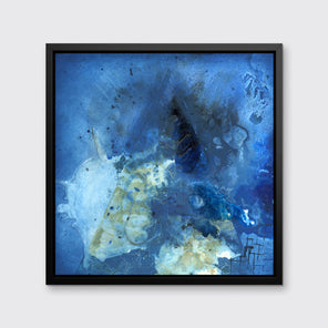 A blue, green and black abstract print in a black floater frame hangs on a white wall.