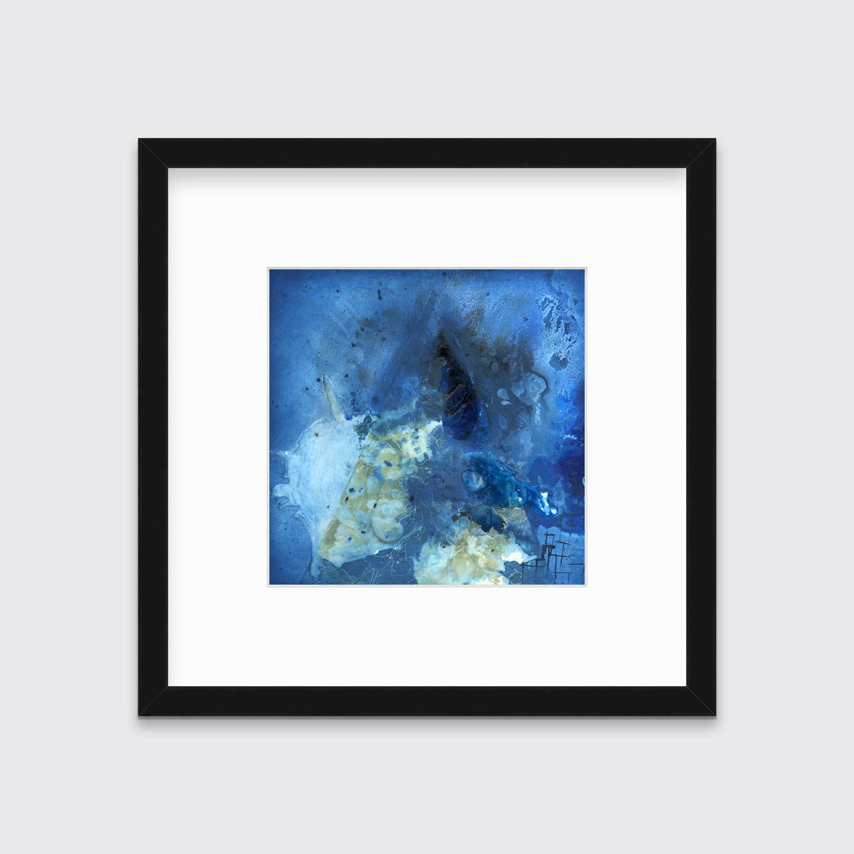 A blue, green and black abstract print in a black frame with a mat hangs on a white wall.
