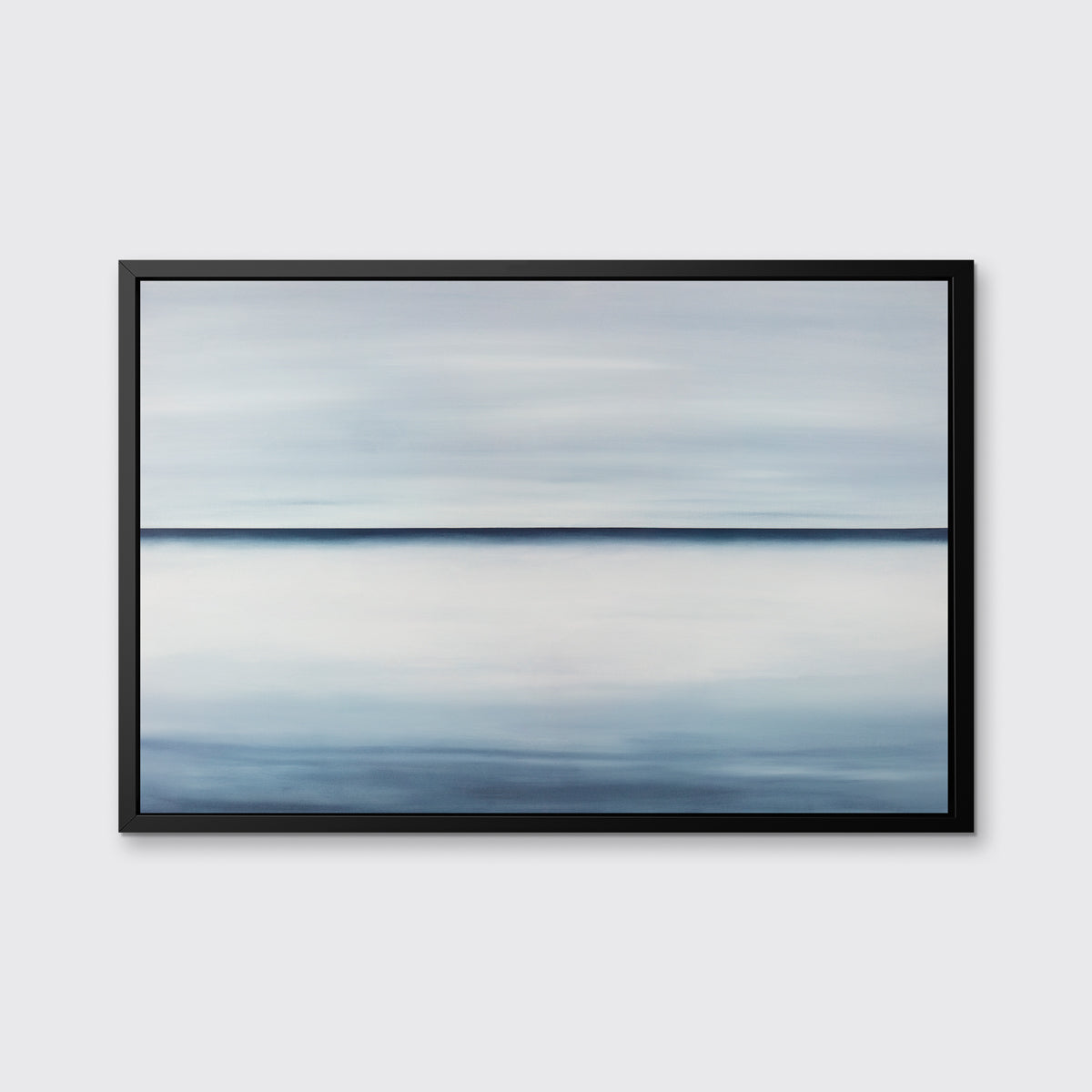 A tonal blue abstract landscape print in a black floater frame hangs on a white wall.