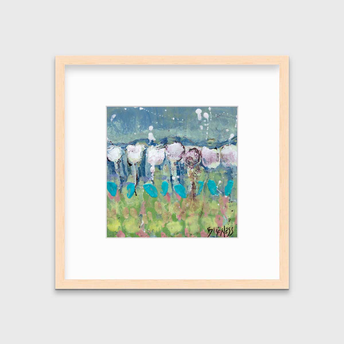A teal, green and white abstract floral print in a natural wood frame with a mat hangs on a white wall.
