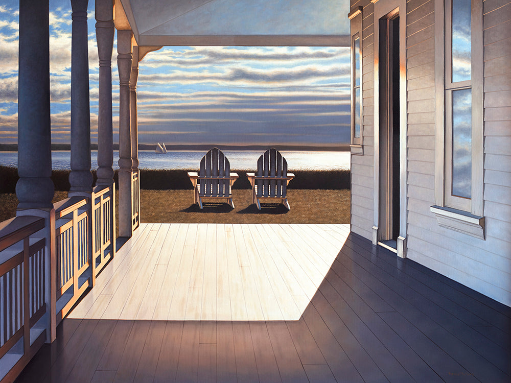 A limited edition print of a contemporary realist painting of the ocean view from a homes porch. Just off the porch in the grass are two lawn chairs looking out the ocean where you can see one lone sailboat out. The setting sun cast a stream of light on to the porch floor being sharply cut off by the house itself. 