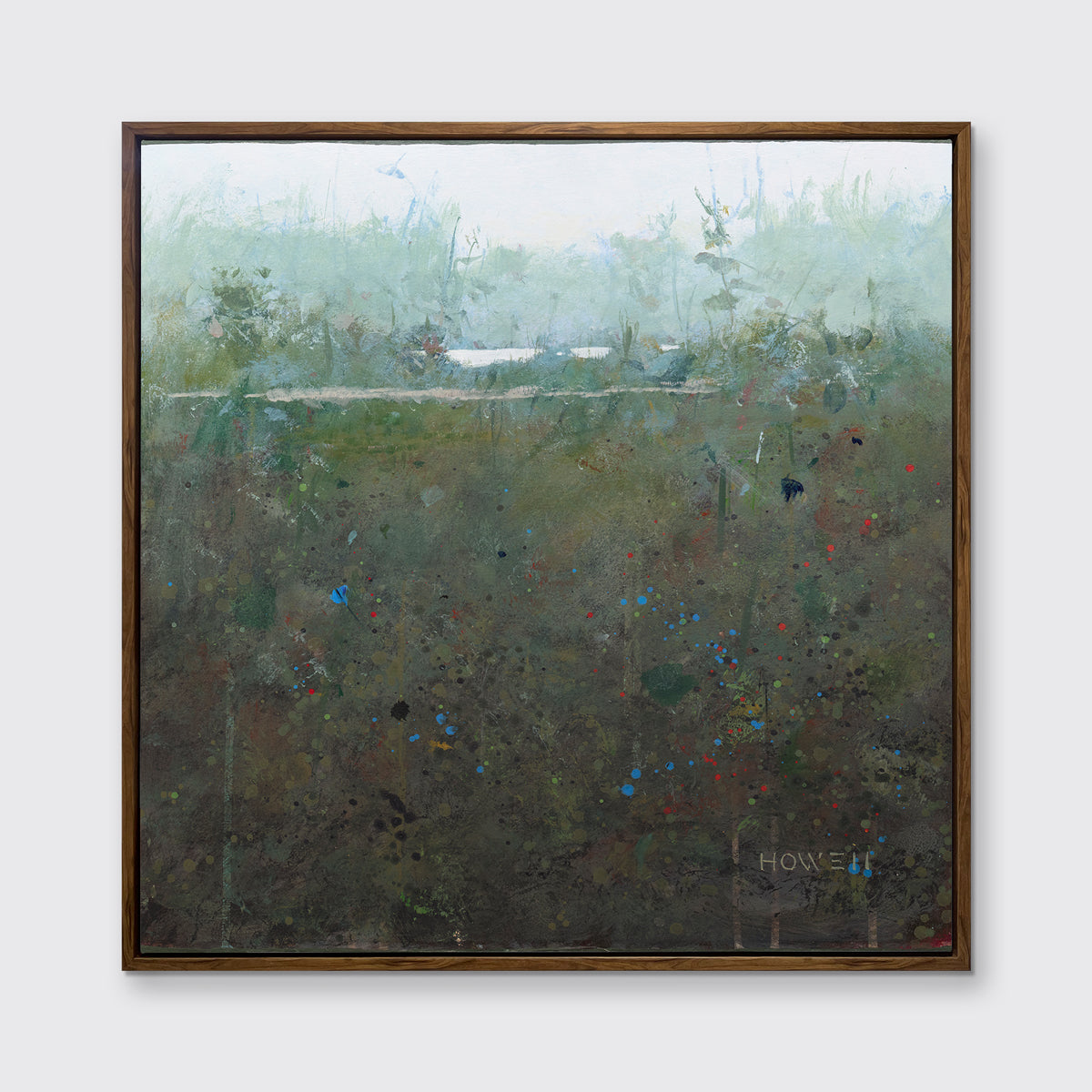 A dark green and grey abstract landscape print in an oak wood floater frame hangs on a white wall.