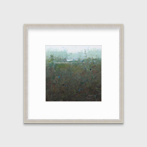 A dark muted green abstract landscape print in a silver frame with a mat hangs on a white wall.
