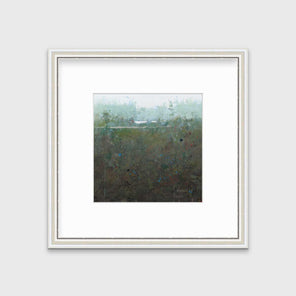 A dark muted green abstract landscape print in a silver frame with antiqued beading with a mat hangs on a white wall.