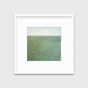 A green and blue abstract landscape print in a white frame with a mat hangs on a white wall.