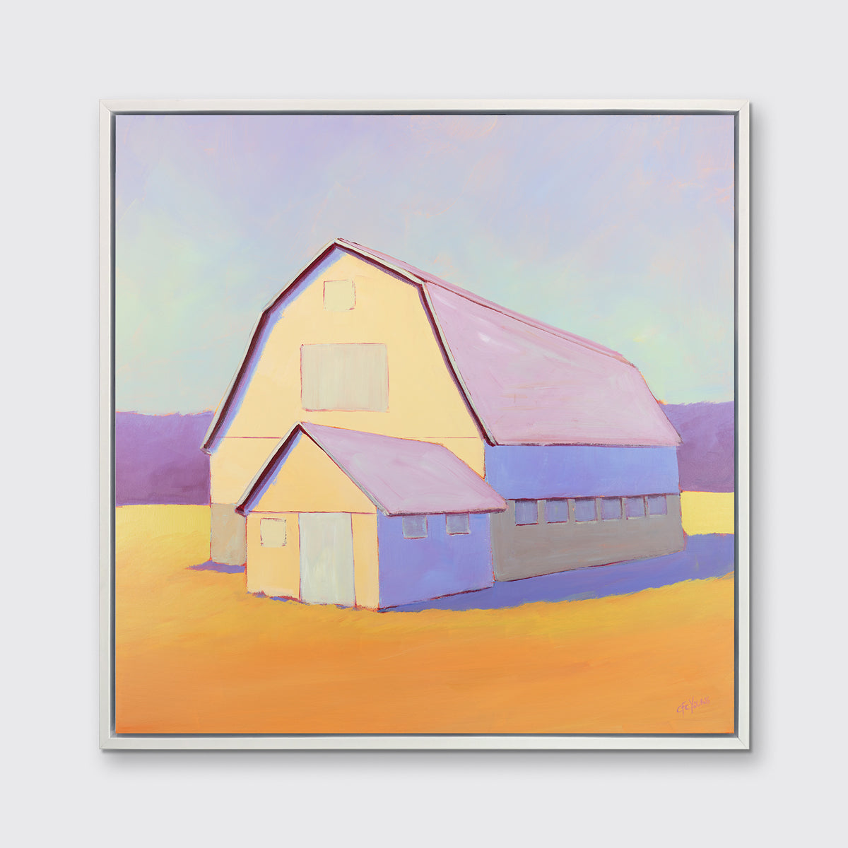 A lavender, light yellow and orange landscape print of a barn in a white floater frame hangs on a white wall.
