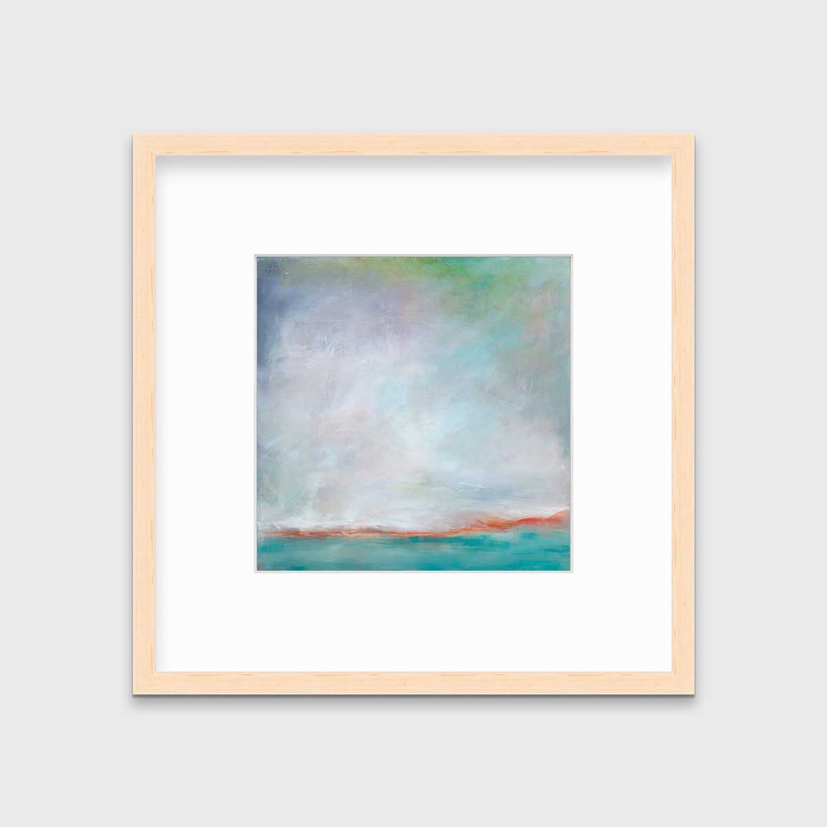 A teal and white abstract print in a natural wood frame with a mat hangs on a white wall.