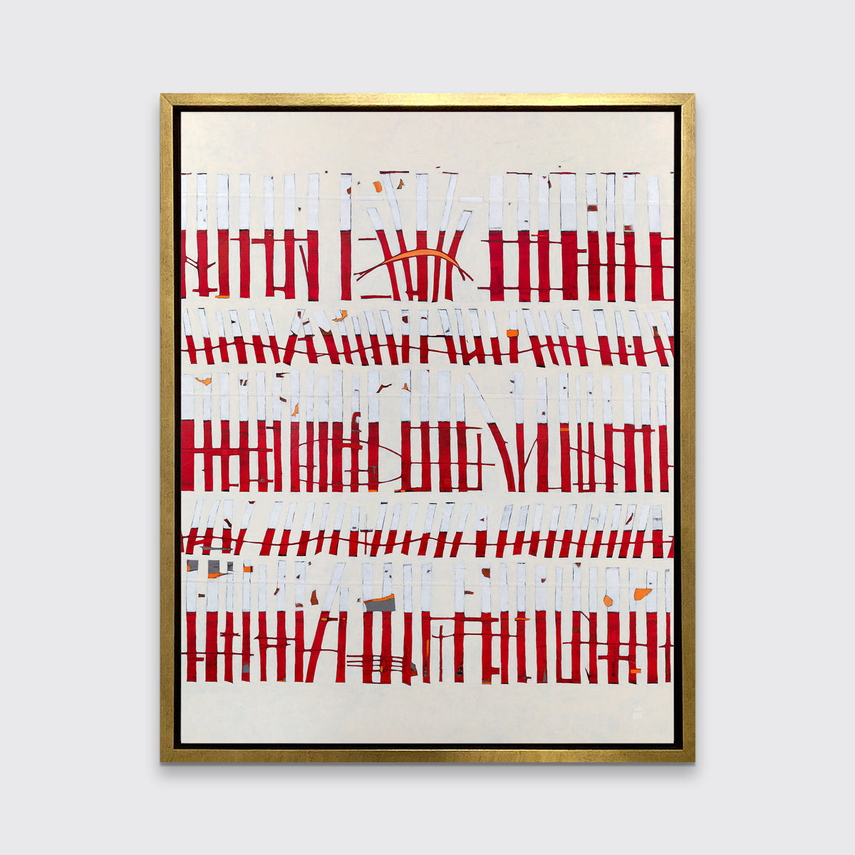 A beige, white and red abstract print in a gold floater frame hangs on a white wall.