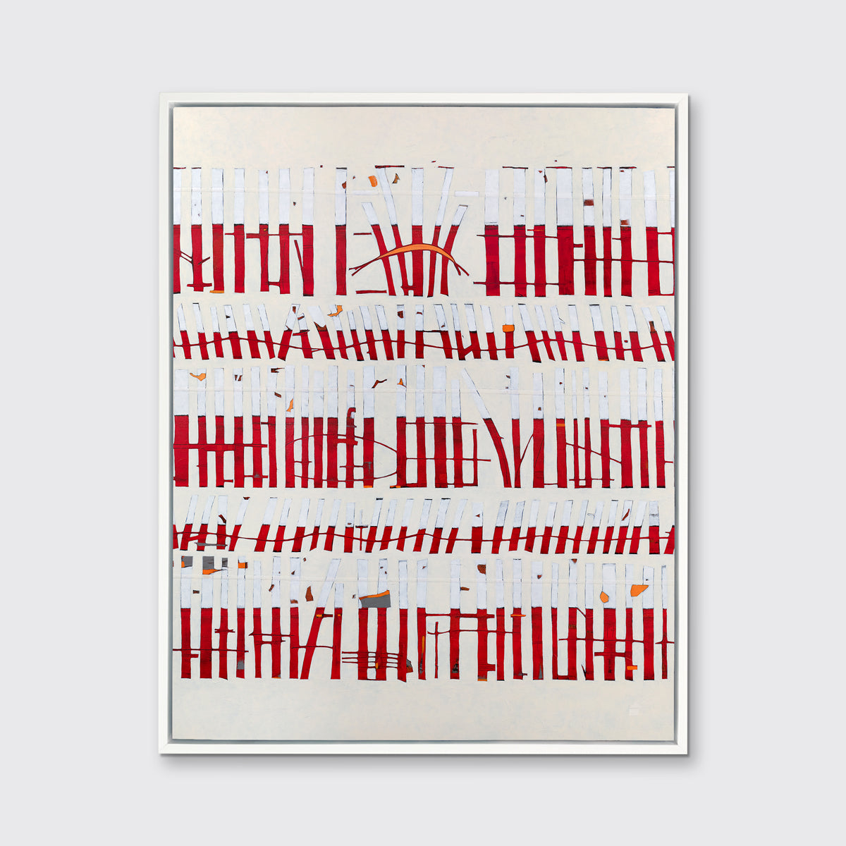 A beige, white and red abstract print in a white floater frame hangs on a white wall.