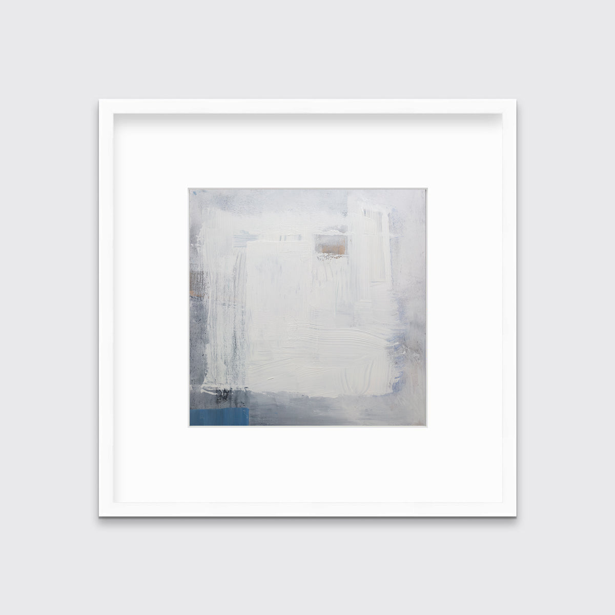 A white, grey and blue abstract print in a white frame with a mat hangs on a white wall.