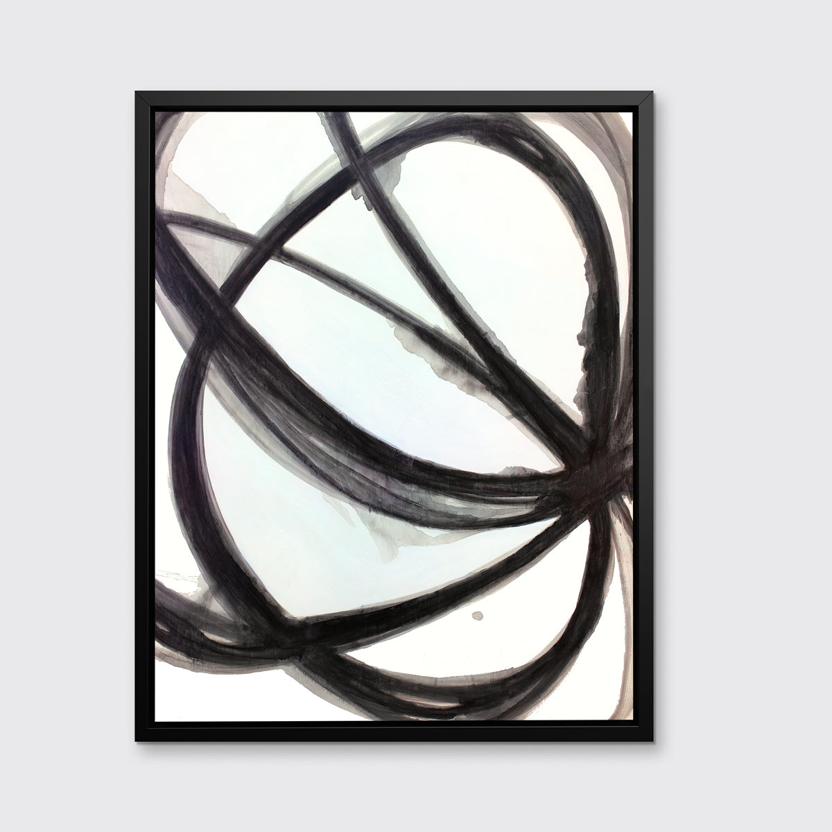 A black and white abstract print by Mary Gaspar, framed in a black floater frame hangs on a light grey wall.