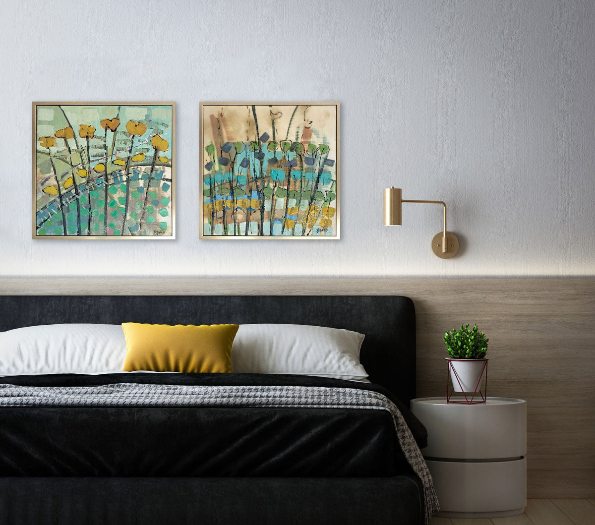 Two framed natured-inspired abstract paintings hang on a grey wall, above a modern bed with black and white linens and a yellow throw pillow, a modern end table and a potted plant. 