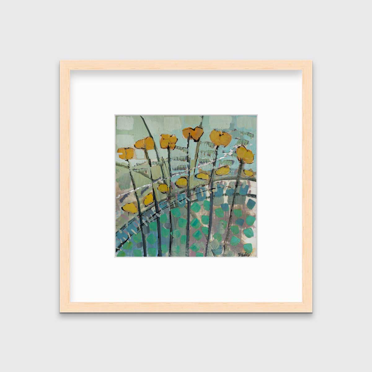 A blue, yellow, and green abstract floral print in a natural wood frame with a mat hangs on a white wall.