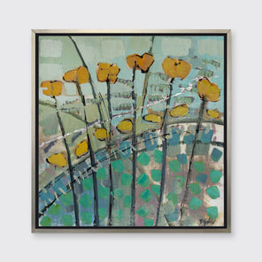 A blue, yellow, and green abstract floral print in a silver floater frame hung on a white wall.