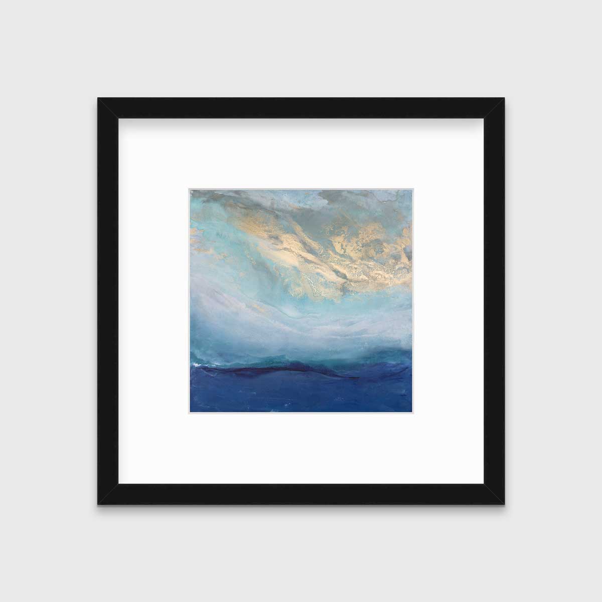 A blue, gold and teal abstract print in a black frame with a mat hangs on a white wall.