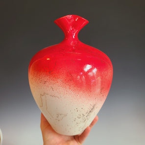 A red and cream ceramic vessel with black accents.