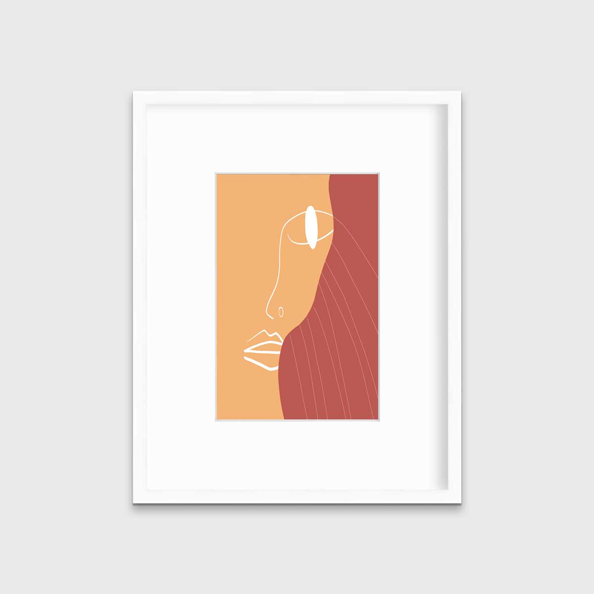 An abstract print with an outline of a woman's face in white and terracotta and beige organic shapes in the background in a white frame with a mat hangs on a white wall.