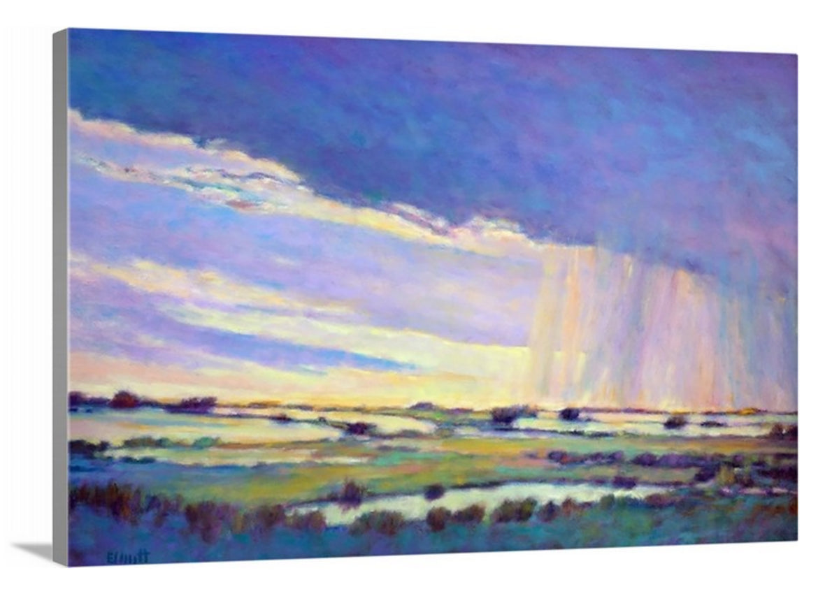 A side-angle view of a blue, purple and yellow abstract landscape print on canvas.