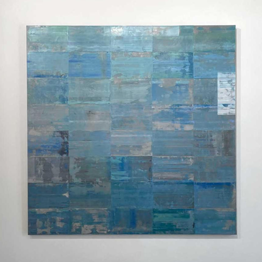 An abstract grid painting with a blue and green wash by Ned Martin hangs on a white wall with a view straight on. 