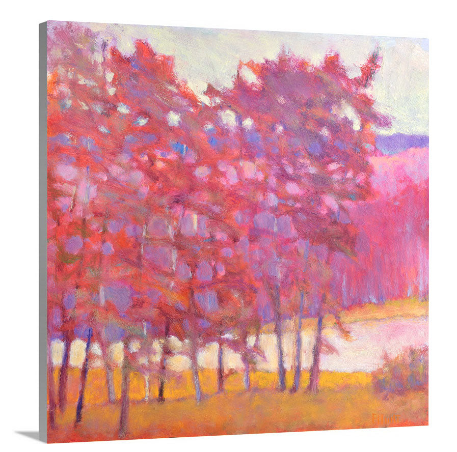 A side-angle view of a red and pink tree landscape print by Ken Elliott on canvas.