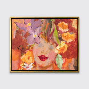 A red, orange, yellow and purple figural print in a gold floater frame hangs on a white wall.