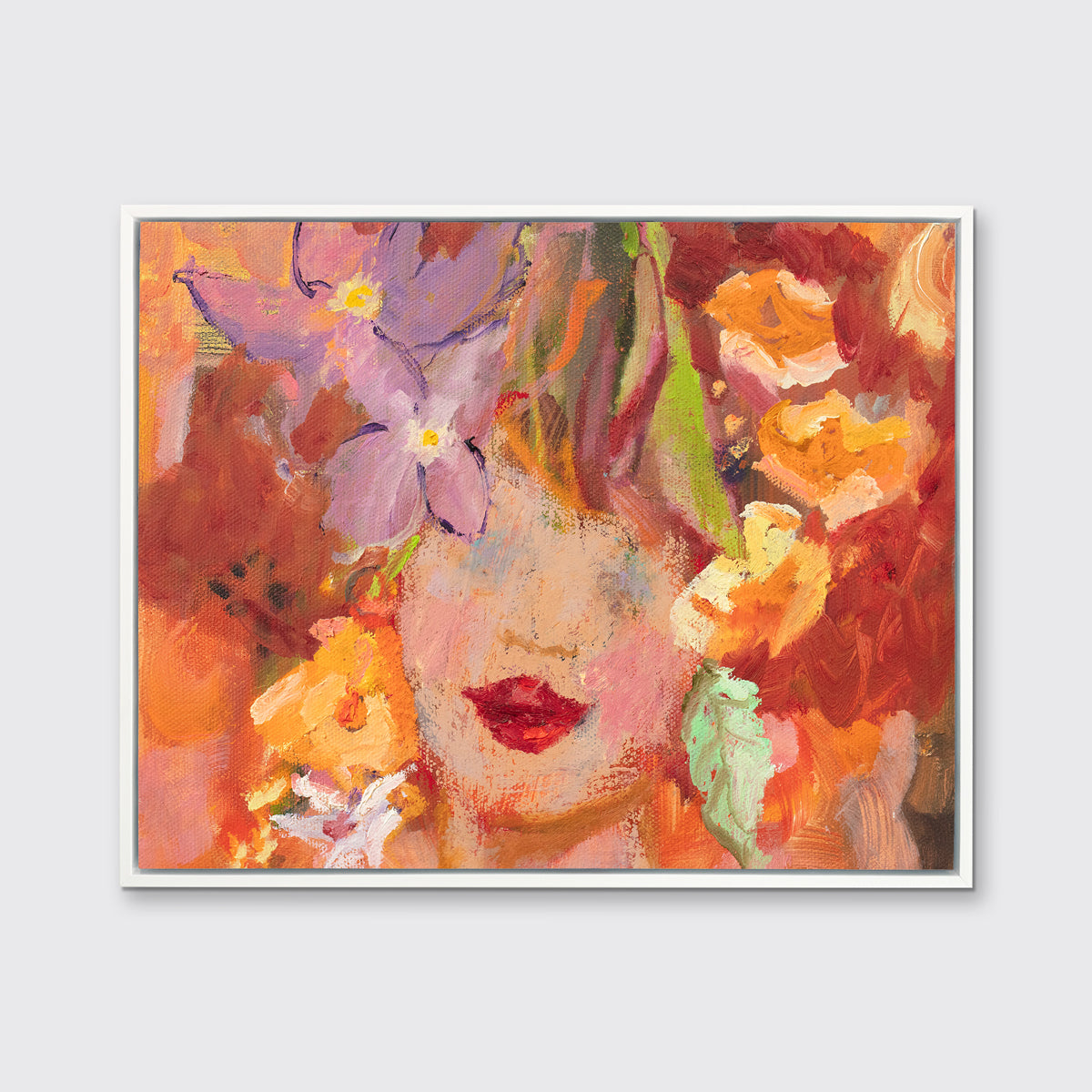 A red, orange, yellow and purple figural print in a white floater frame hangs on a white wall.