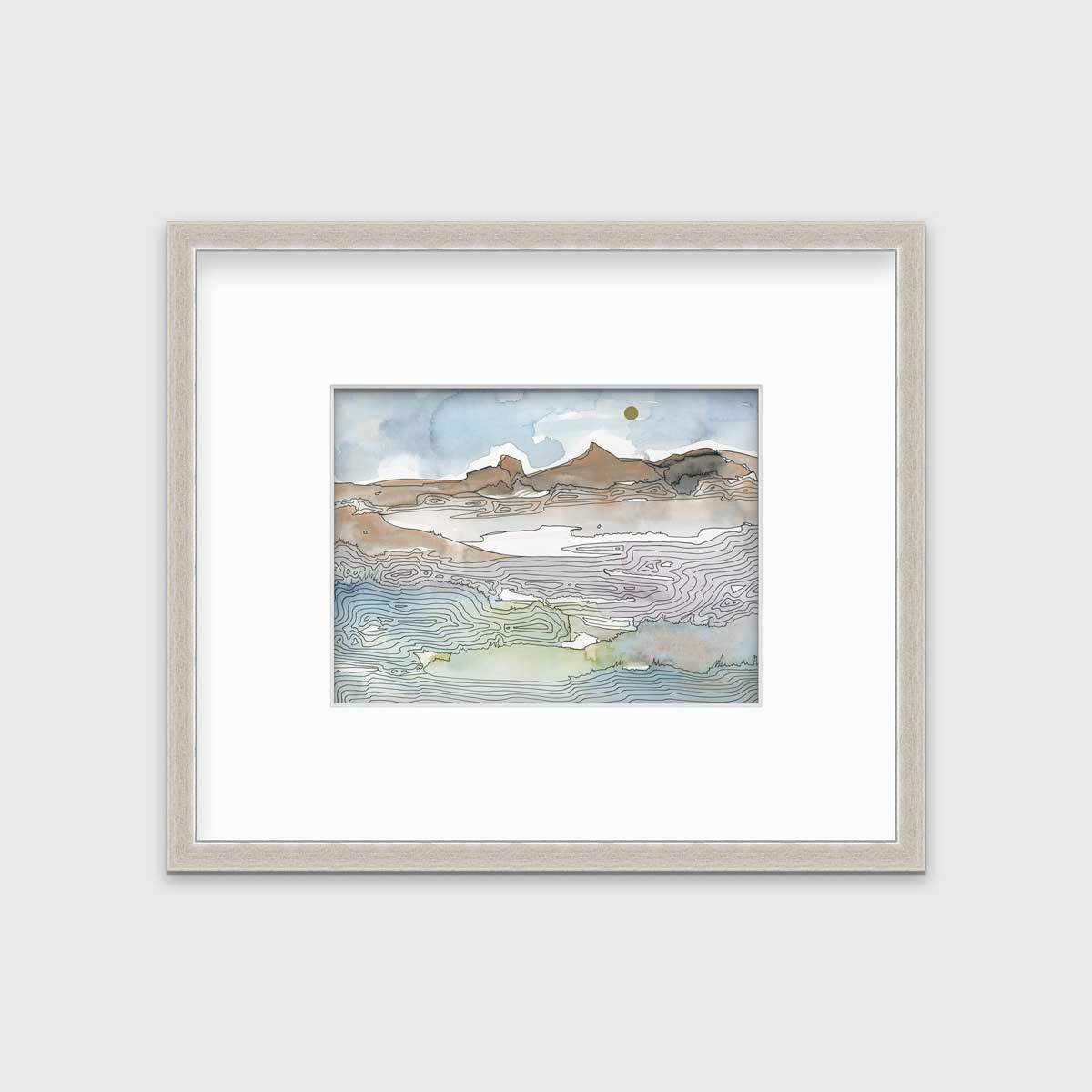 A blue, brown and light green abstract landscape print in a silver frame with a mat hangs on a white wall.