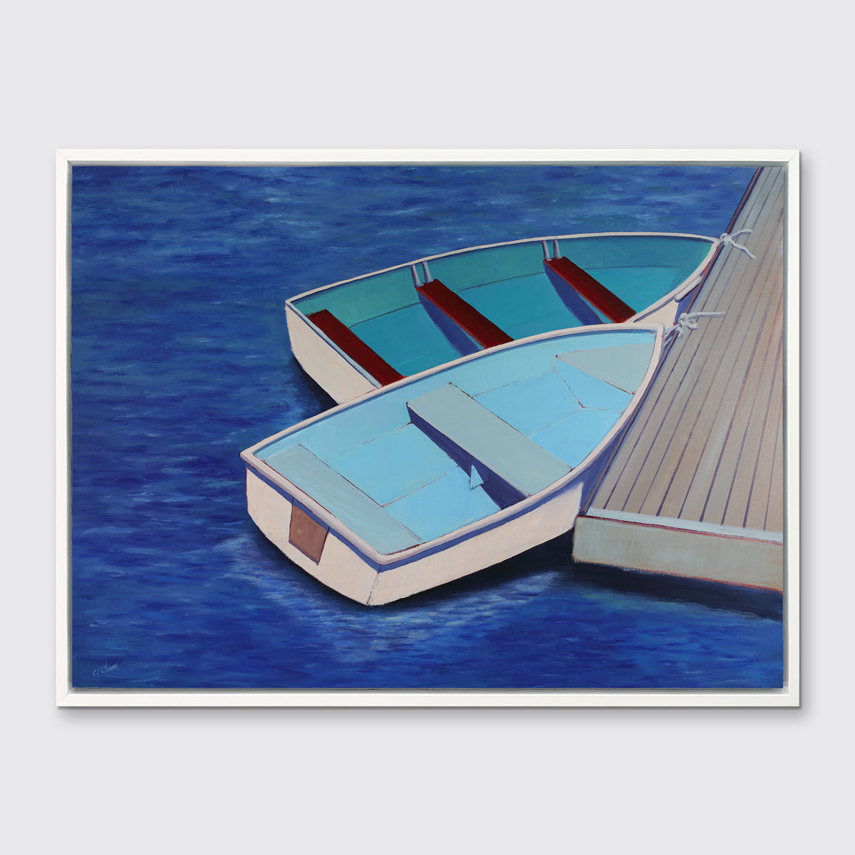 A blue, light blue and beige contemporary nautical print of two docked rowboats in a white floater frame hangs on a white wall.