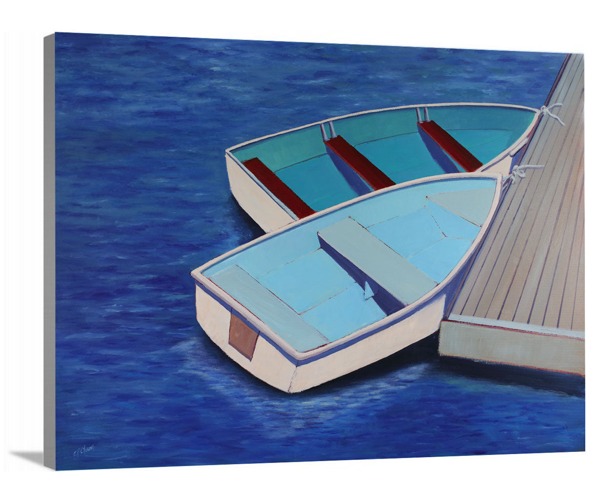 A side-angle view of a blue, light blue and beige contemporary nautical print of two docked rowboats on canvas.