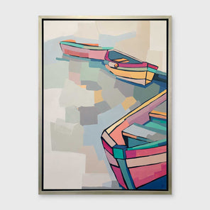 A pastel multicolored abstract print of boats in a silver floater frame hangs on a white wall.