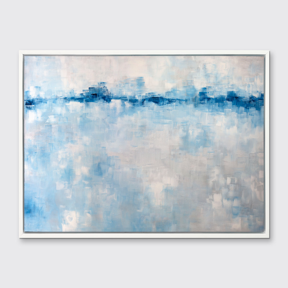 A blue and white abstract print in a white floater frame hangs on a white wall.