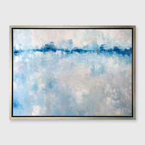 A blue and white abstract print in a silver floater frame hangs on a white wall.