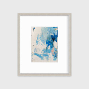 A blue, peach and white abstract print in a silver frame with a mat hangs on a white wall.