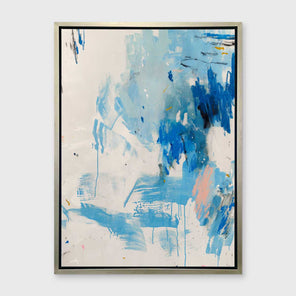 A blue, peach and white abstract print in a silver floater frame hangs on a white wall.
