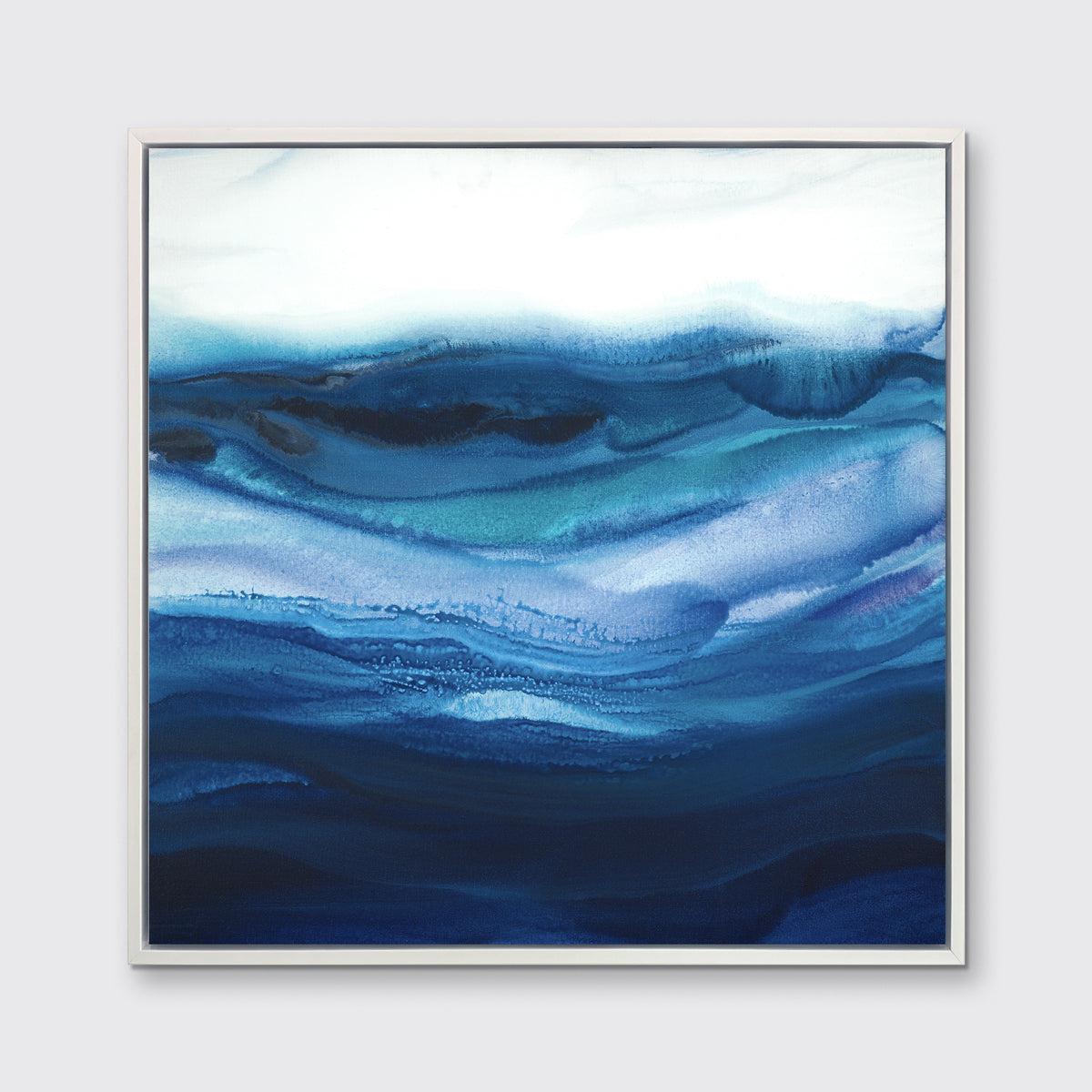 A blue, teal and white abstract print in a white floater frame hangs on a white wall.