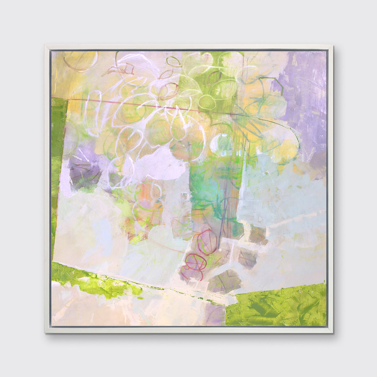 A light yellow, lavender and green abstract floral print in a white floater frame hangs on a white wall.