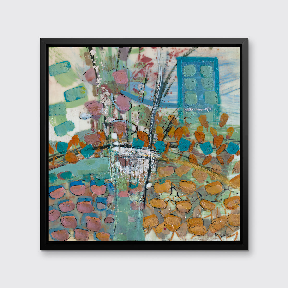 A multicolored print, framed in a black floater frame, hangs on a light grey wall.
