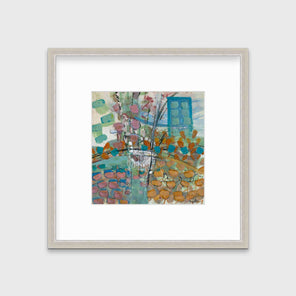 A multicolored abstract print, matted and framed in a silver frame hangs on a grey wall.