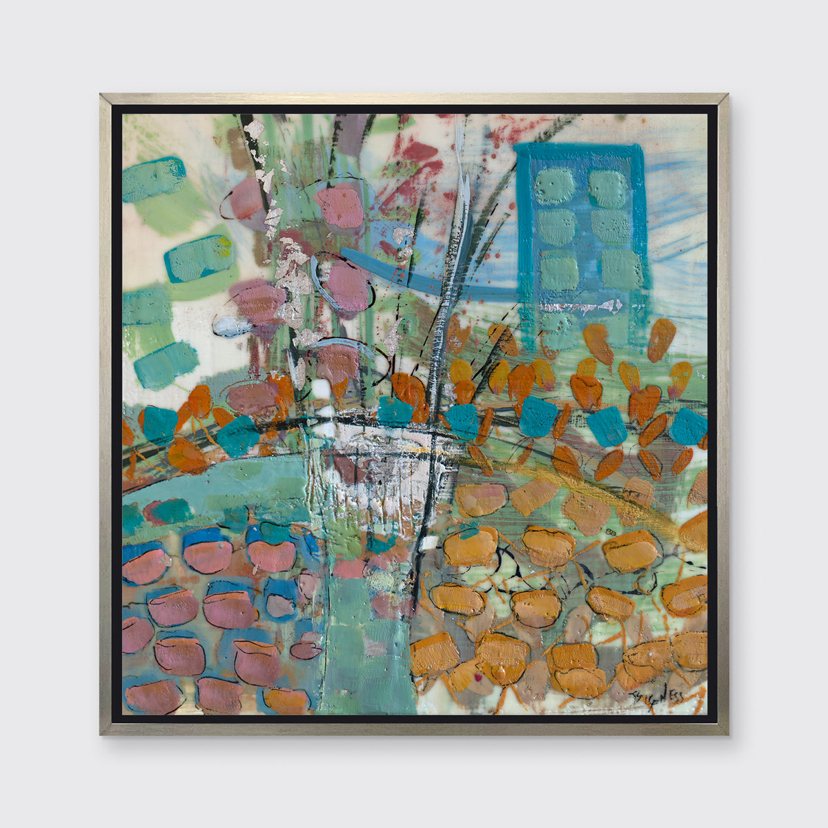 A multicolored abstract print framed in a warm silver floater frame hangs on a light grey wall.