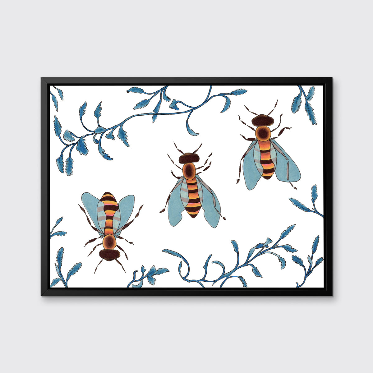 Three orange and brown bees surrounded by blue ferns in a black floater frame hangs on a white wall.