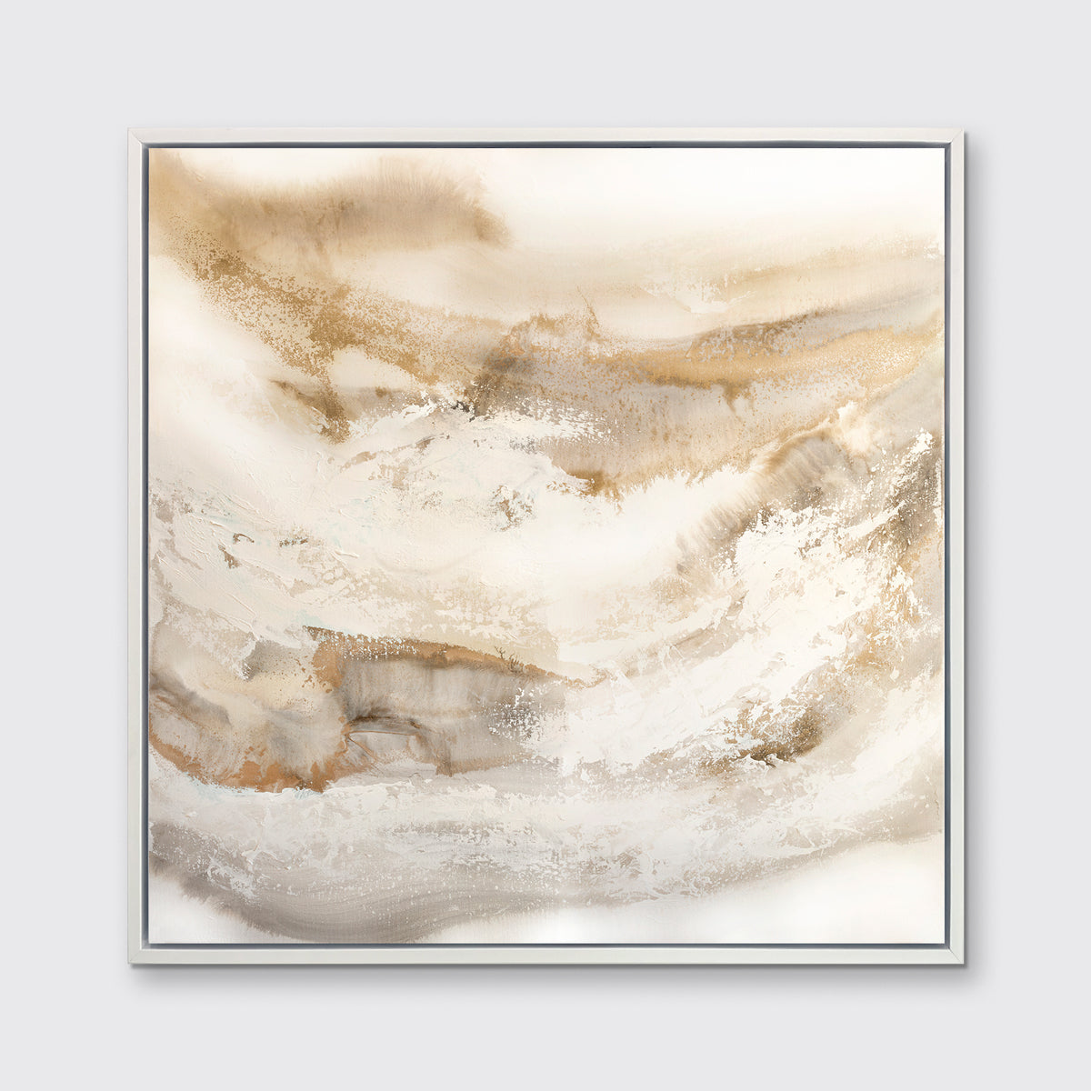 A gold, silver, white and beige abstract print in a white floater frame hangs on a white wall.