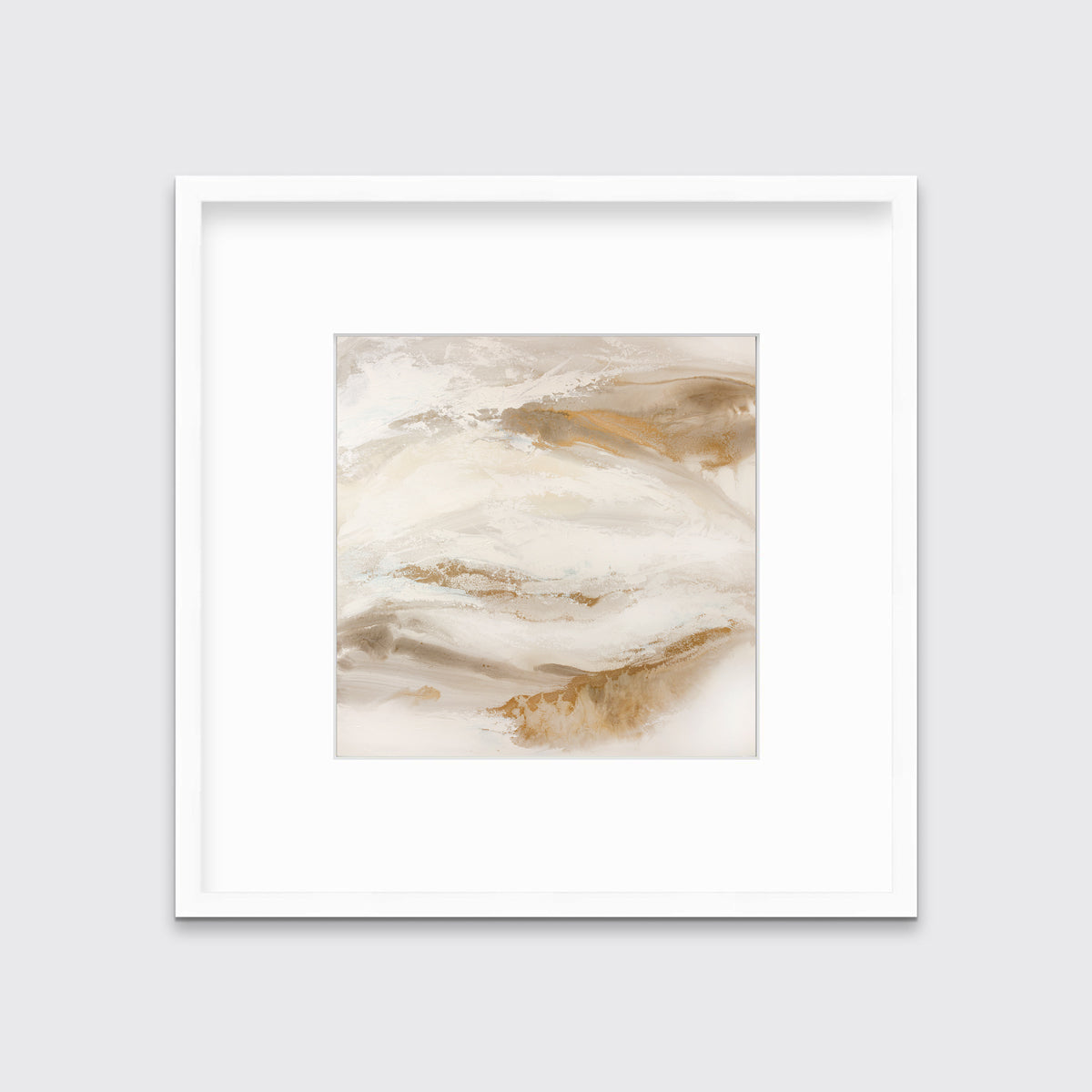 A gold, silver, white and beige abstract print in a white frame with a mat hangs on a white wall.