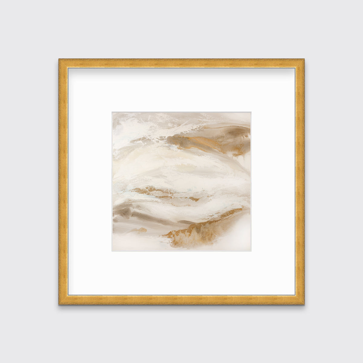 A gold, silver, white and beige abstract print in a gold frame with a mat hangs on a white wall.